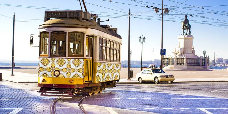 Vintage yellow tramway at the Commerce Square in Lisbon, Portugal