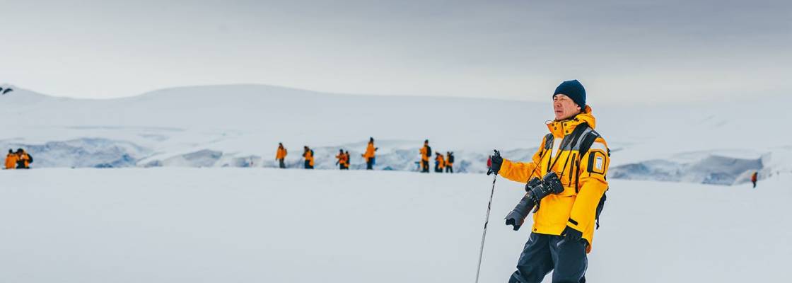 Guests traveling with Quark Expeditions enjoy some off-ship exploration while hiking in Antarctica.