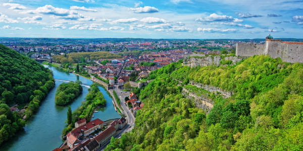 The iconic Citadel of Besançon towering over the city and the Doubs River, showcasing the unique fortified landscape of this UNESCO World Heritage site in Franche-Comté, Burgundy, France.
