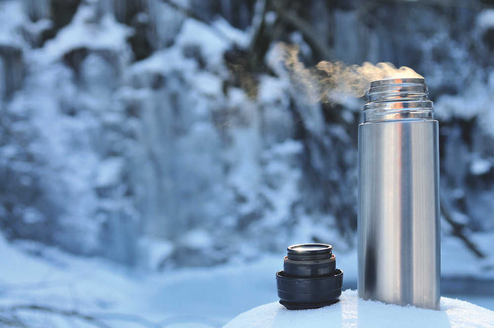 Thermos flask in the snow