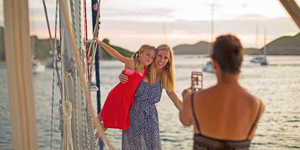 Family taking photos on beach