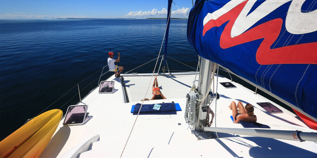 Sailing catamarans offer space for sunbathing and water sports equipment.