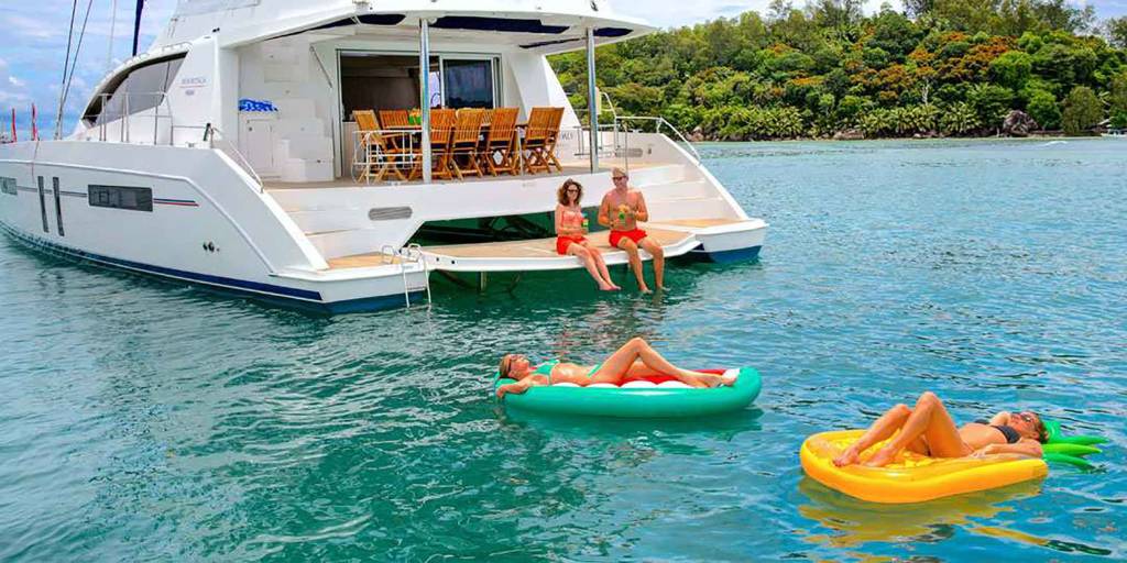 People relaxing on inflatable rafts in Caribbean