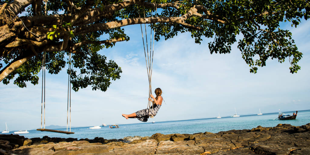 Woman swinging on tree swing