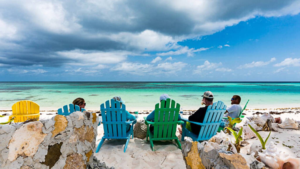 four people sitting on the beach