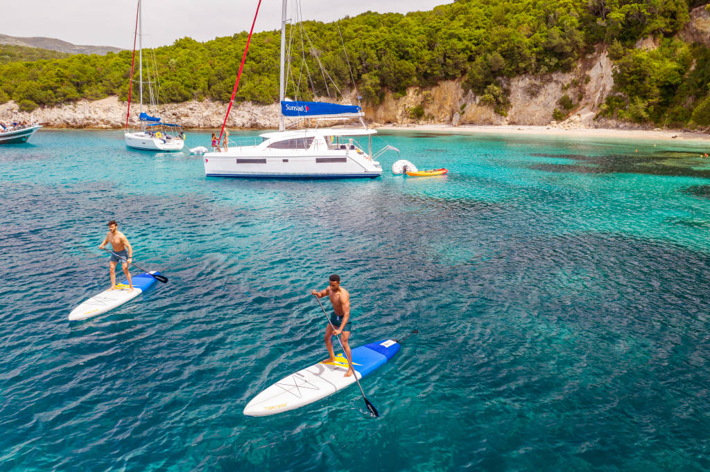 Sailing in Corfu with people paddleboarding