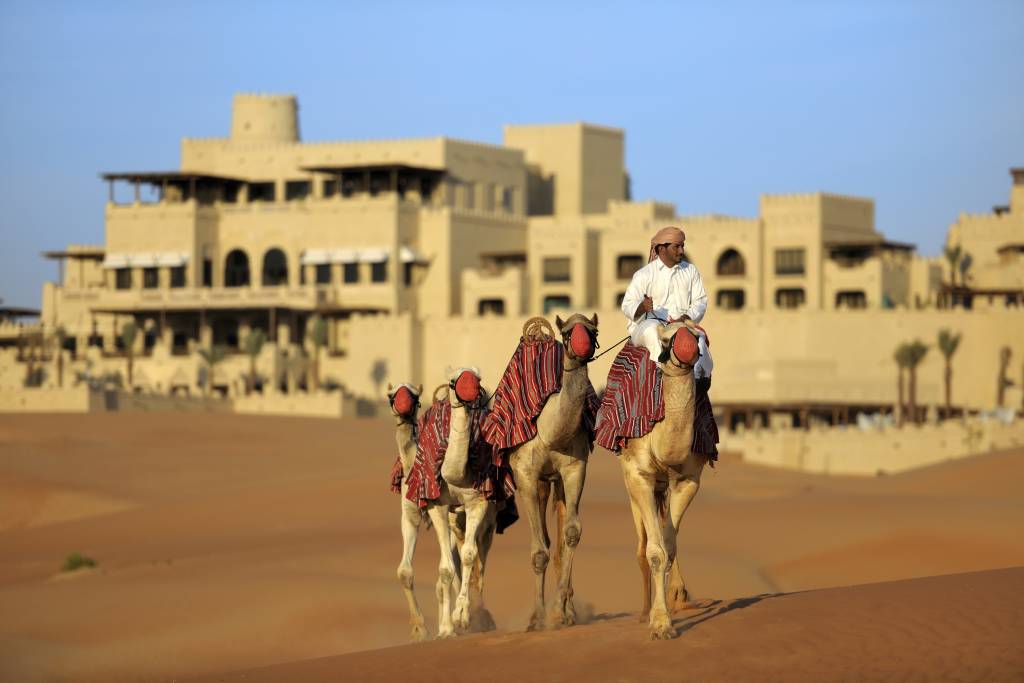 Enchanting Travels UAE Tours Abu Dhabi Hotels Qasr Al Sarab Desert Resort by Anantara Camel_trekking