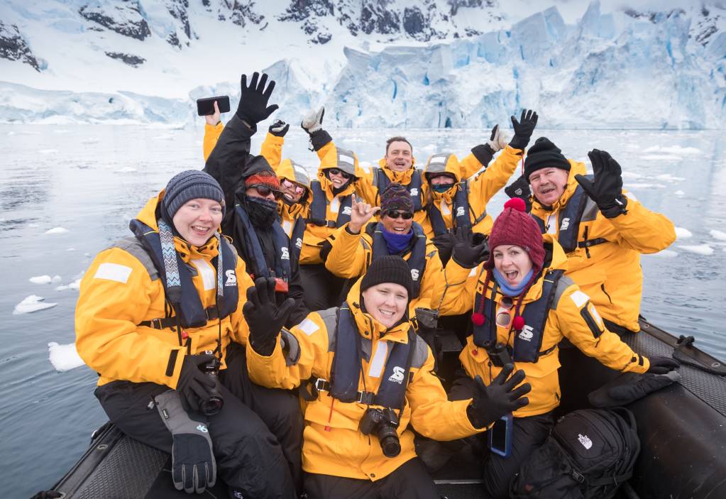 Guests pose for a group photo during a Zodiac cruise.