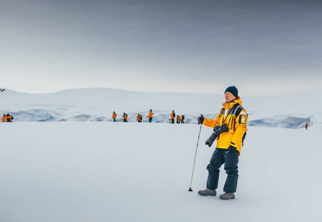 Guests traveling with Quark Expeditions enjoy some off-ship exploration while hiking in Antarctica.