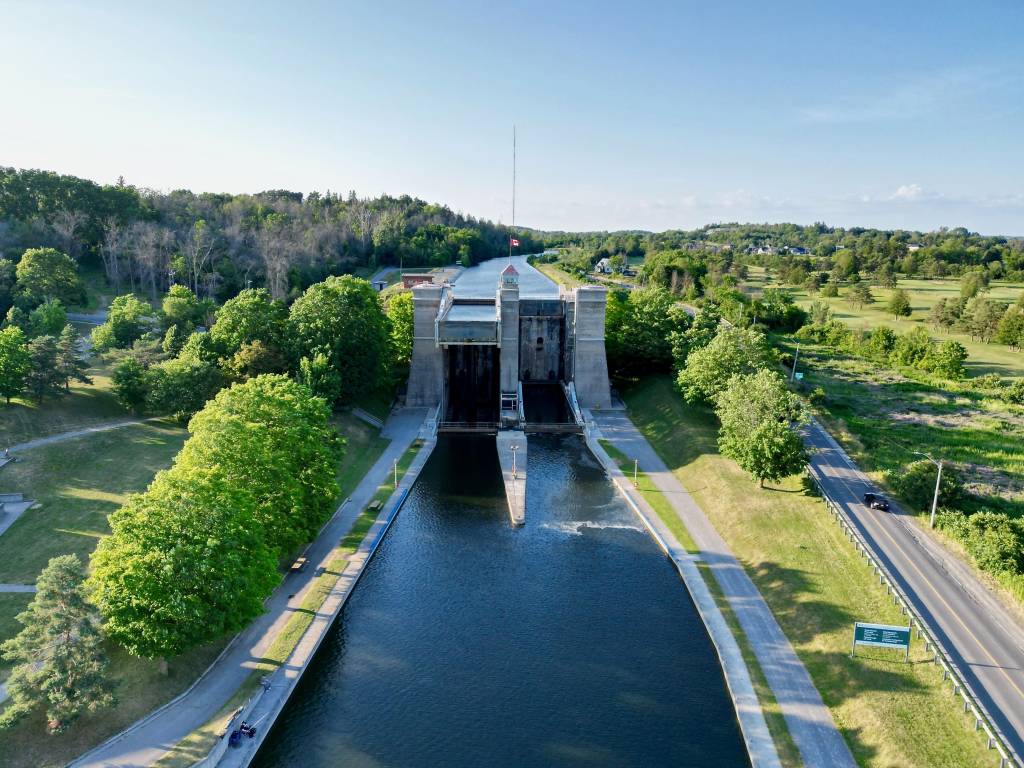 Aerial view of the Trent‑Severn Lift Lock canal in Ontario, surrounded by greenery and clear skies on a summer day.