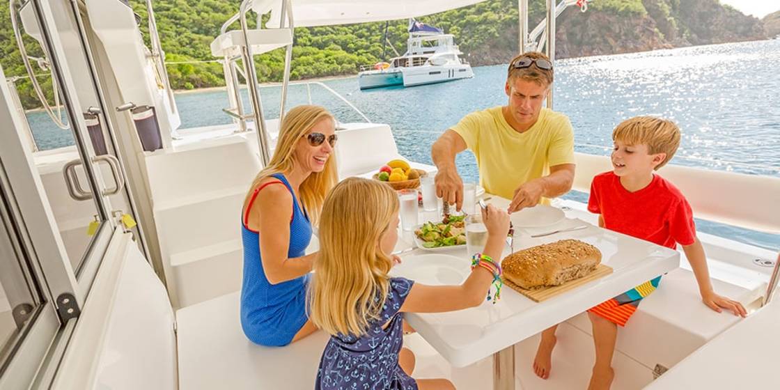 Family eating aboard a catamaran
