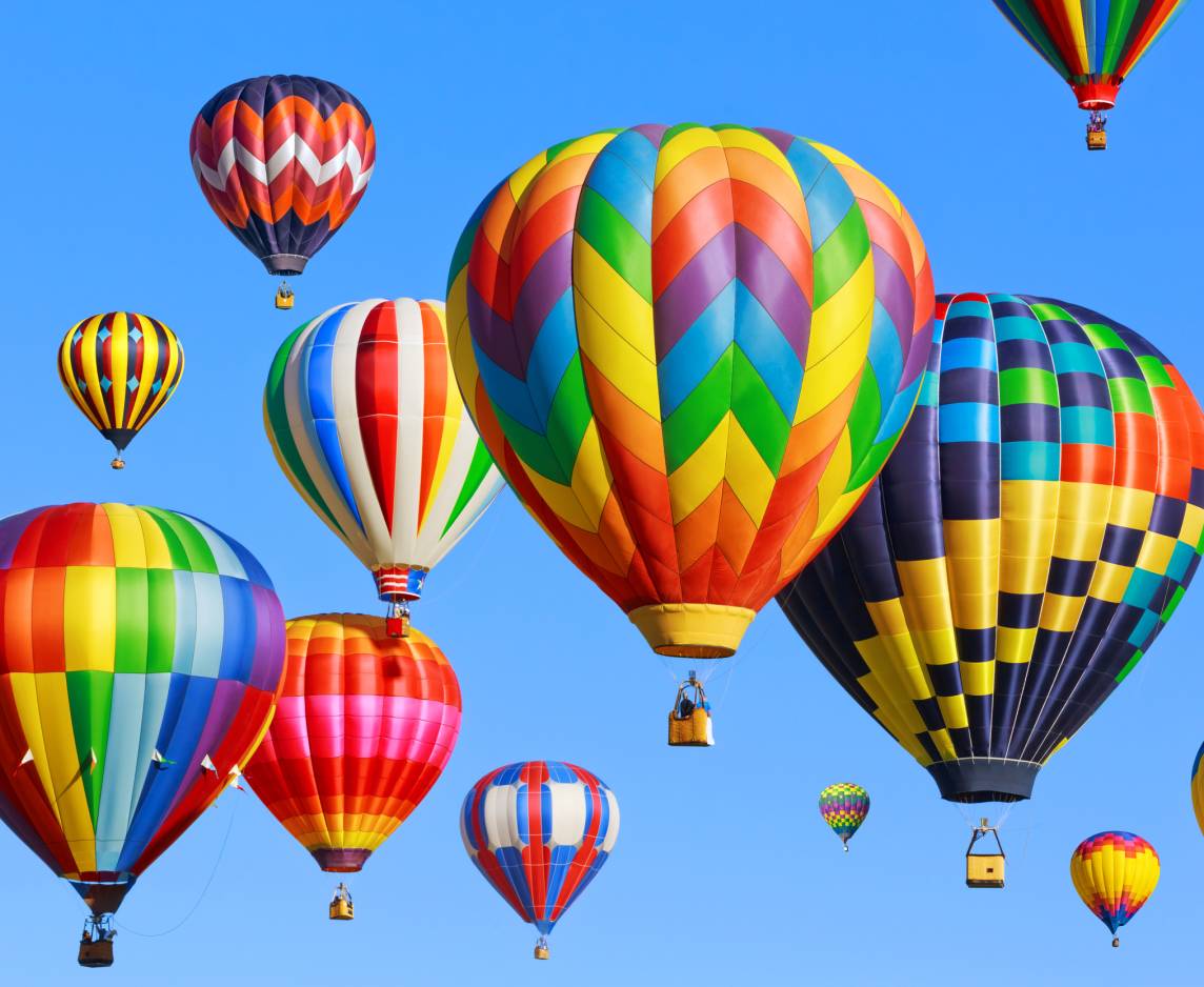 Colorful hot air balloons soaring in the sky at the 2025 Albuquerque Event