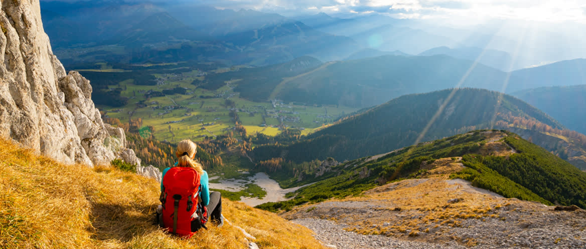 Hiker sits at a peak