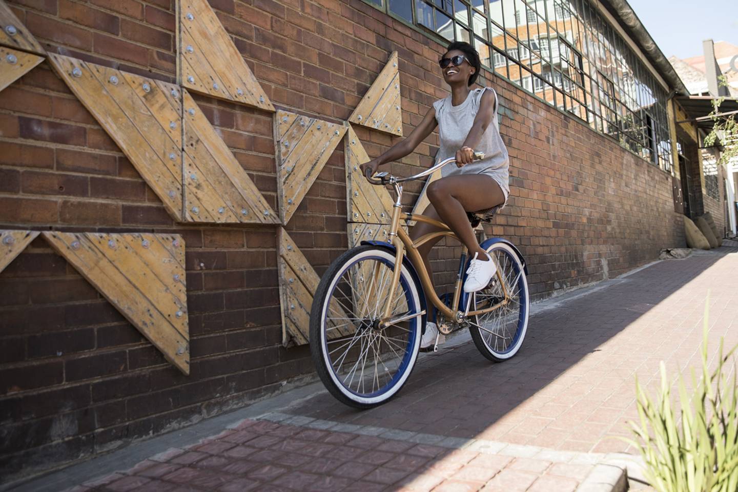 woman riding bicycle next to wall