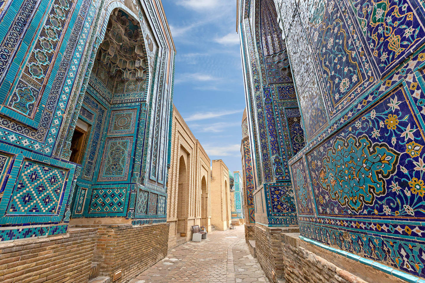 small street between blue tiled buildings