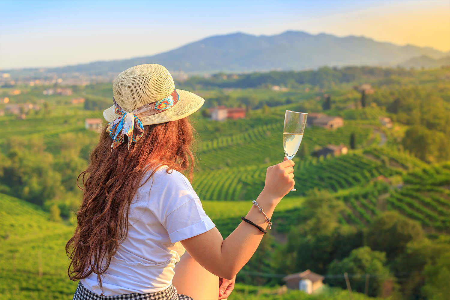 Woman sips white wine in Italy