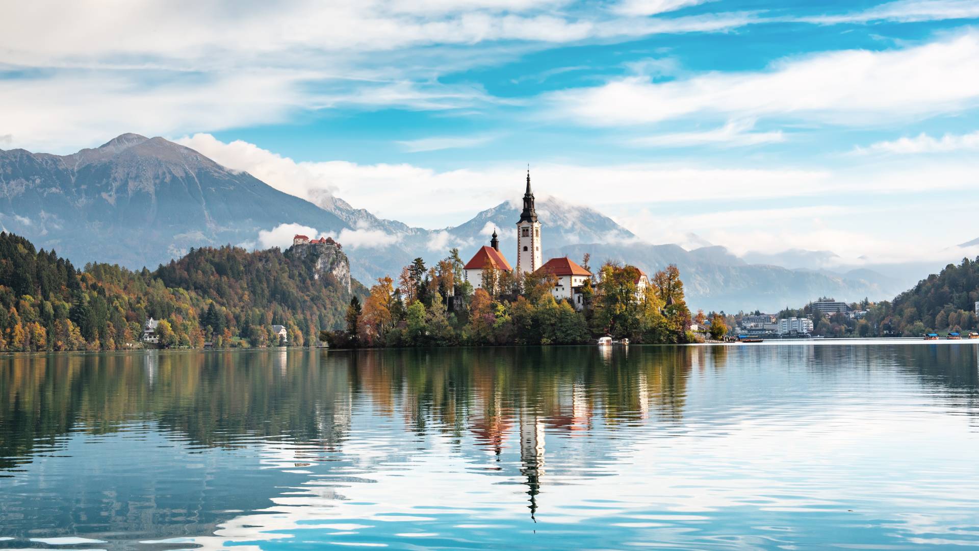 Church of Assumption in Lake Bled, Slovenia with blue sky and clouds in the autumn