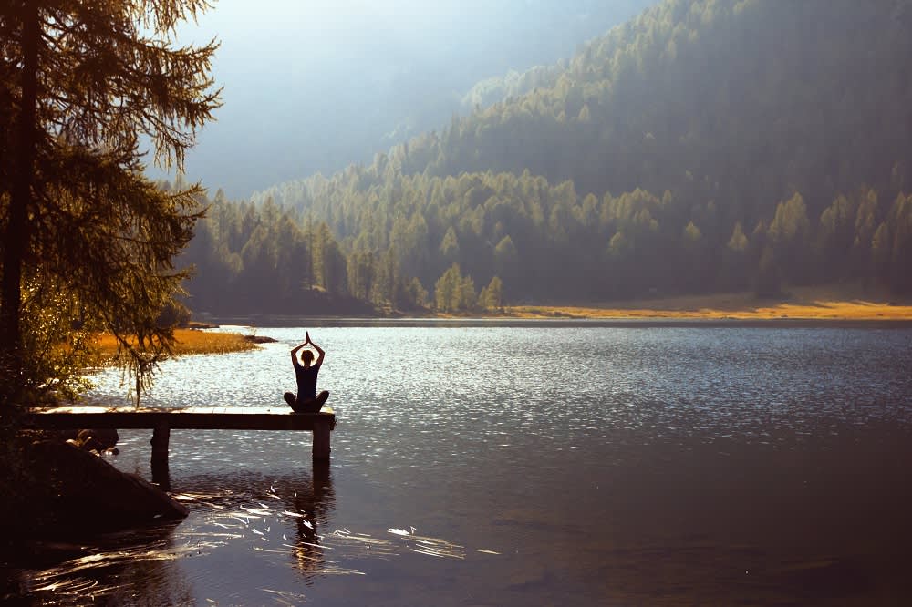 Meditation and yoga practicing at sunset