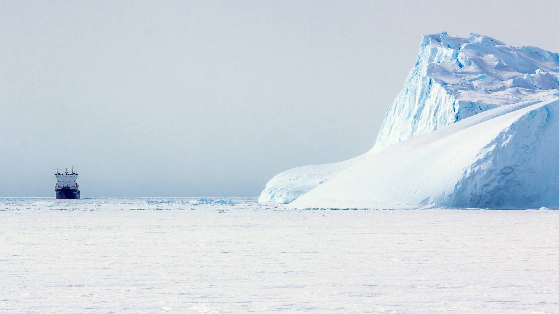 Ship near an icebergs and ice on the water Antarctic - things to do in Antarctica