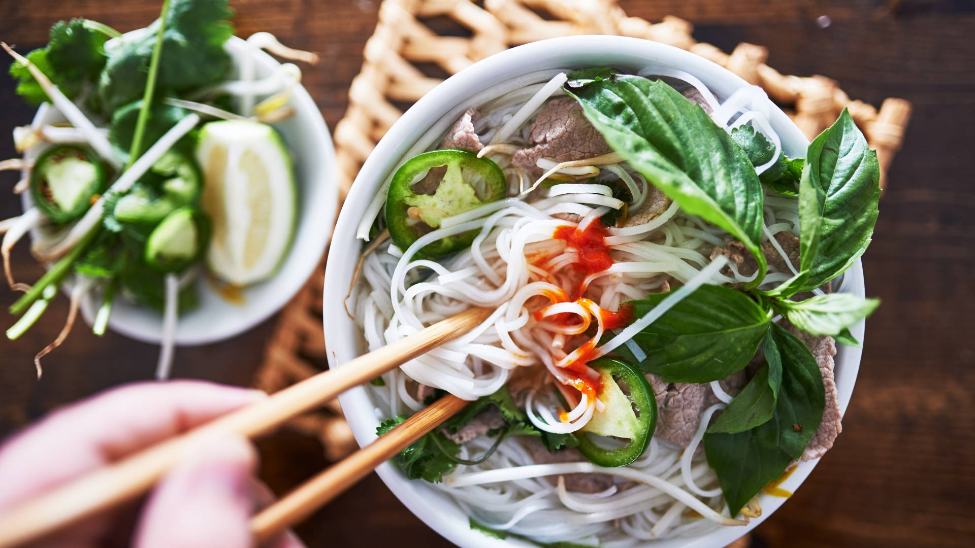 vietnamese pho with spicy sriracha sauce shot top down