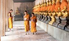 a group of people walking on a sidewalk