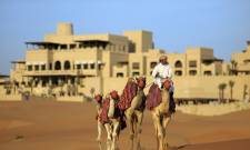 Enchanting Travels UAE Tours Abu Dhabi Hotels Qasr Al Sarab Desert Resort by Anantara Camel_trekking