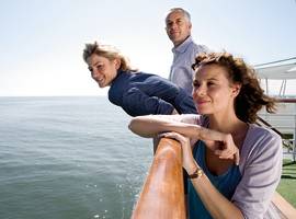 The guests are viewing scenery from the ship's sundeck