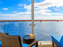 Two tropical alcoholic drinks on a balcony veranda table with a view of the sea