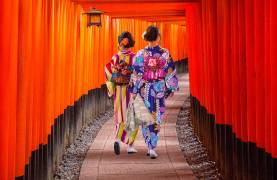 Top 10 temples in Japan - Women in traditional japanese kimonos walking at Fushimi Inari Shrine in Kyoto, Japan