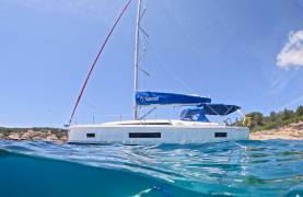 split image of a Sunsail yacht and person swimming below the ocean surface