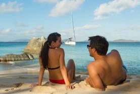 Couple at the Baths on Virgin Gorda BVI with Moorings monohull in the background