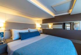 Moorings 534PC cabin with a double berth, upholstered headboard, and an overhead hatch.