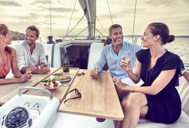 Guests enjoying a meal on yacht deck