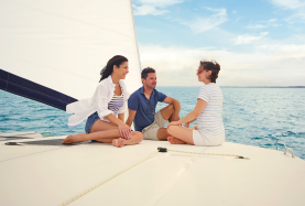 Friends sitting on catamaran and talking