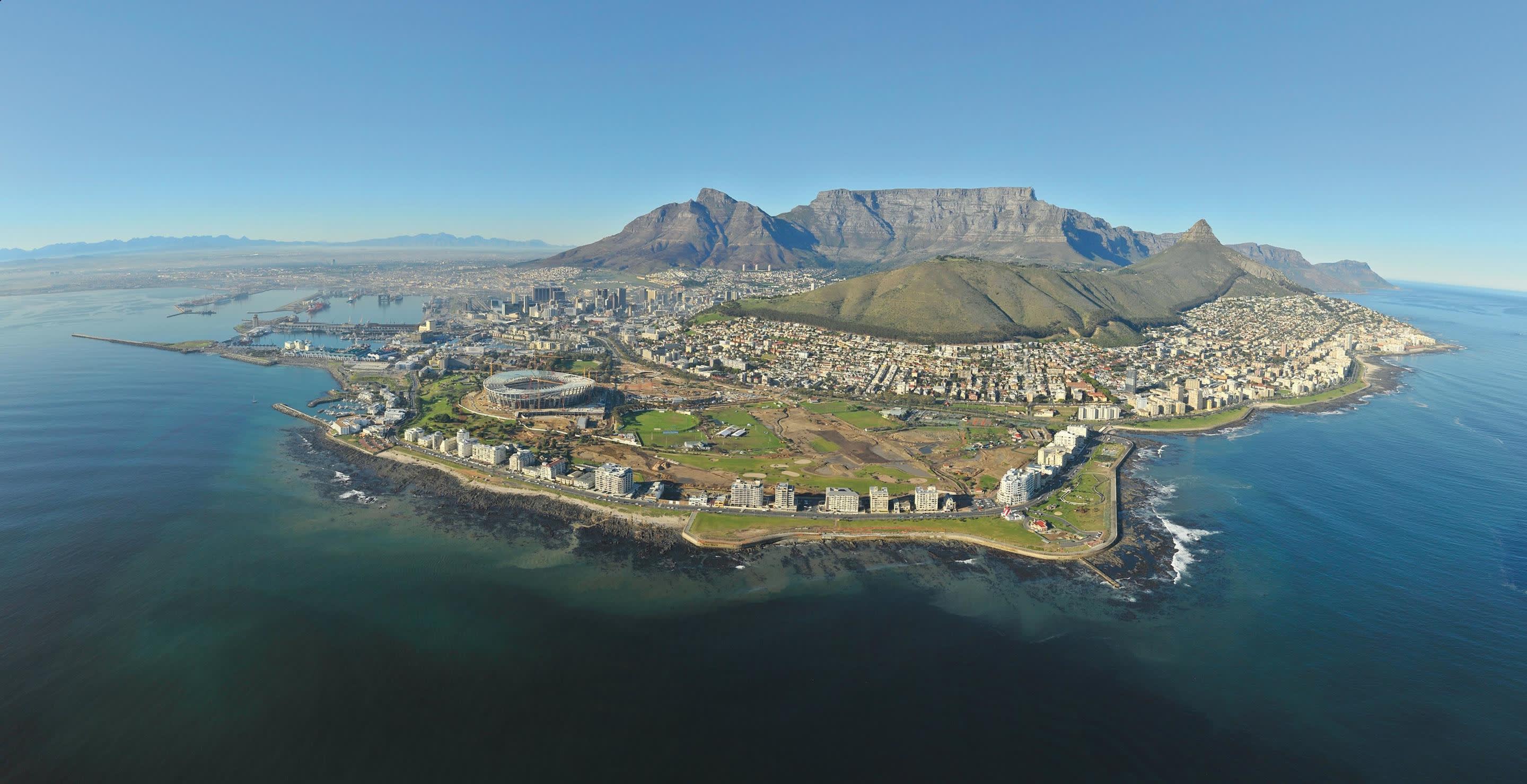 a large body of water with a mountain in the background
