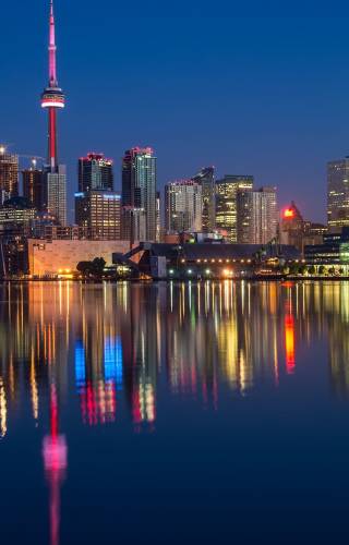 a body of water with a city in the background