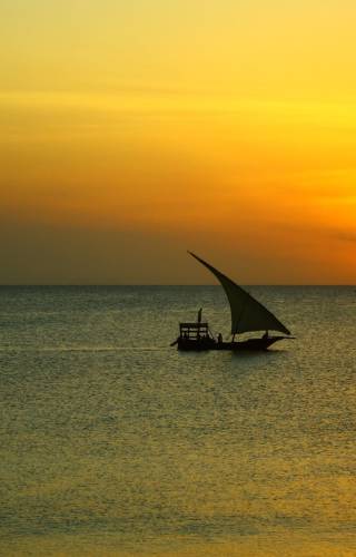 a yellow sunset over a body of water