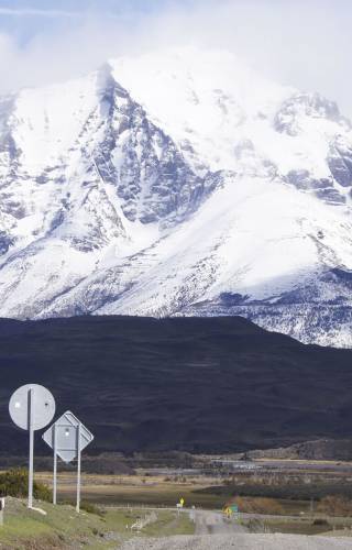 a sign on the side of a snow covered mountain