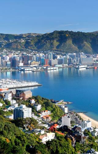 a large body of water with a city in the background