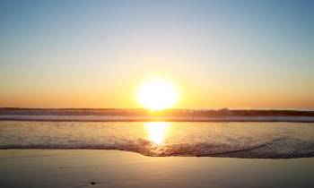 a sunset over a body of water