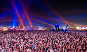 a group of people on a stage with a crowd watching