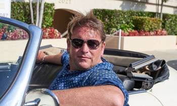 James Martin wearing sunglasses driving a car