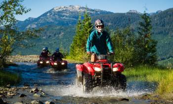 a man riding a motorcycle down a river