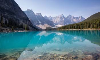 a body of water with a mountain in the background