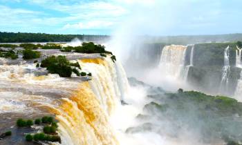 a large waterfall over some water with Iguazu Falls in the background