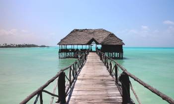 a wooden pier next to a body of water