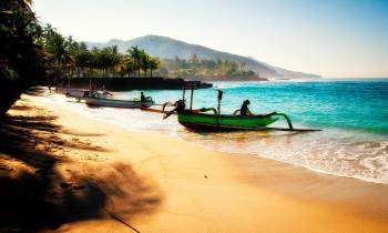 a boat sitting on top of a sandy beach