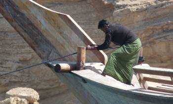 a man sitting on top of a wooden ramp