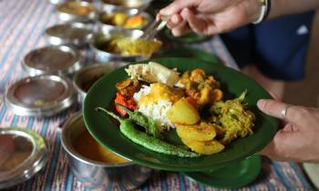 a person holding a plate of food