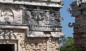 a large stone statue in front of a brick building